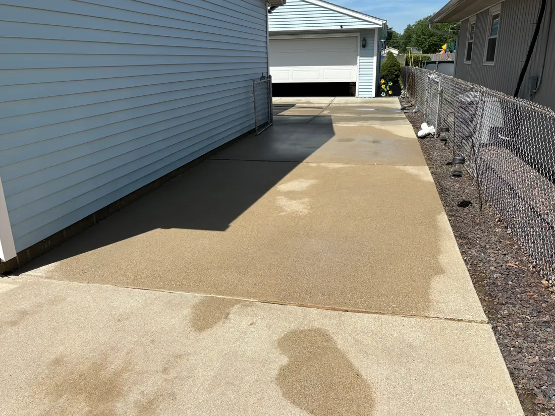 Concrete driveway after power washing — clean, even surface