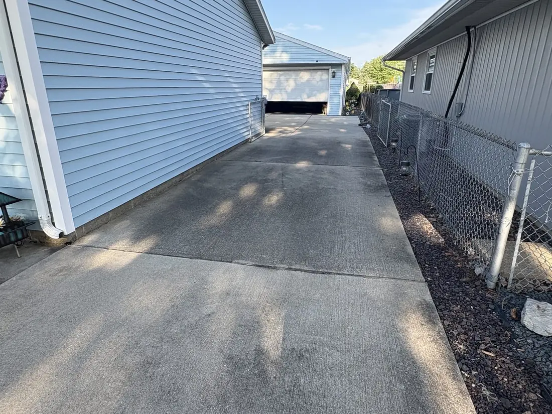 Concrete driveway before power washing — stained, dirty surface
